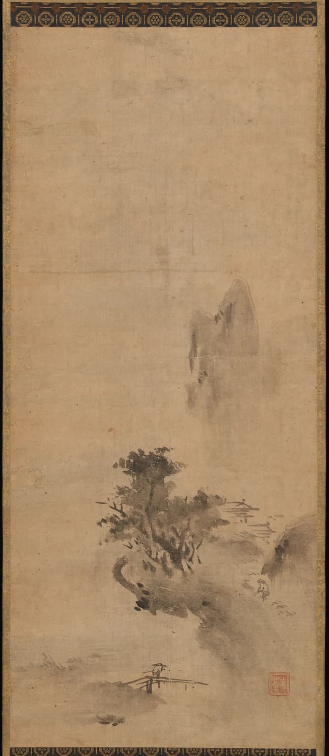 Bokushō Shūshō, Splashed-Ink Landscape, early 16th century — a wet rock and tree cluster low on a hanging scroll whose top third is bare untouched ground, with a pale half-dissolved mountain at mid-height