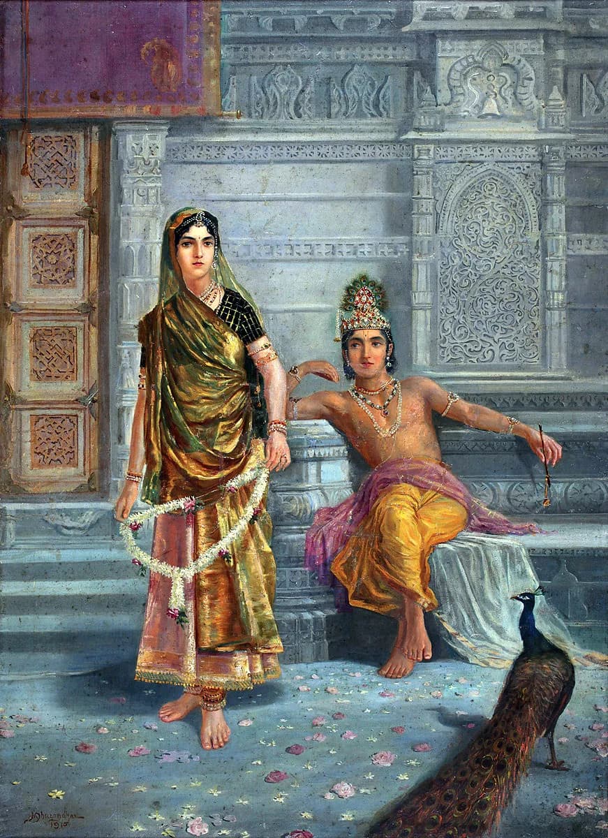 M. V. Dhurandhar, Radha and Krishna, 1915 — oil painting of a standing woman holding a long white flower garland that hangs in a loop from both hands, before a crowned figure seated on a stone ledge against carved grey temple stone, with a peacock at the lower right and petals scattered on the floor