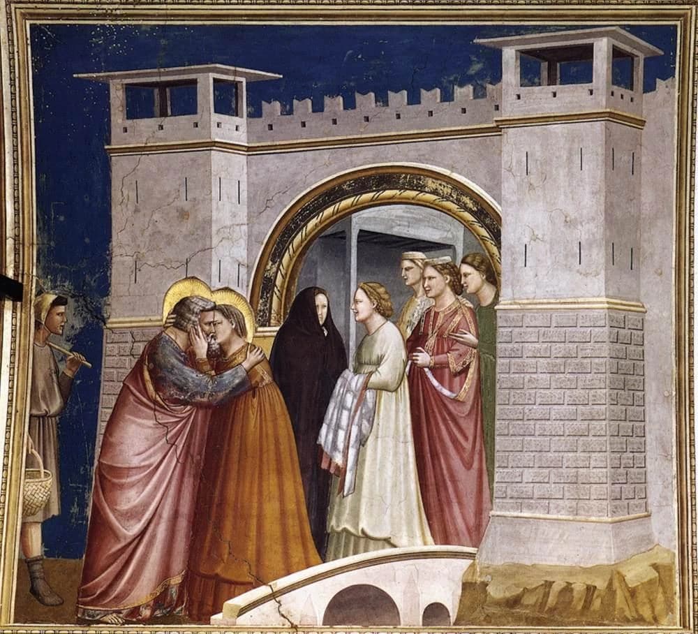 Giotto di Bondone, Meeting at the Golden Gate, 1303–1305 — a bearded man and a woman embrace on a low stone bridge before a crenellated city gate with two towers, four women watching from the gateway and a shepherd with a basket at the far left, against a flat dark blue ground